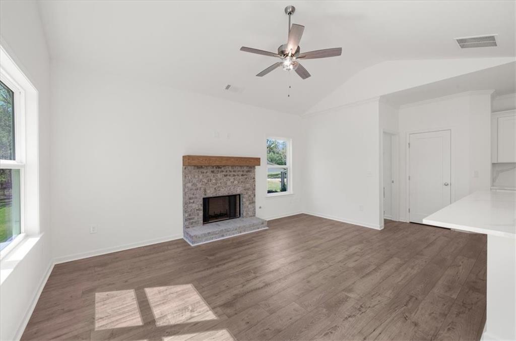 8905 Bethel Road Gainesville, GA 30506 - Photo 28 of 72 an empty room with windows fireplace and a sink