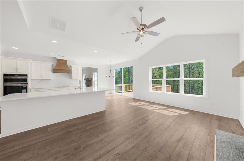 8905 Bethel Road Gainesville, GA 30506 - Photo 29 of 72 a view of an empty room with wooden floor and a window