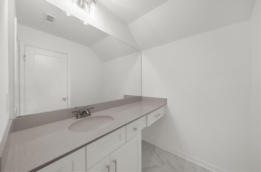 8905 Bethel Road Gainesville, GA 30506 - Photo 54 of 72 a bathroom with a sink and a mirror