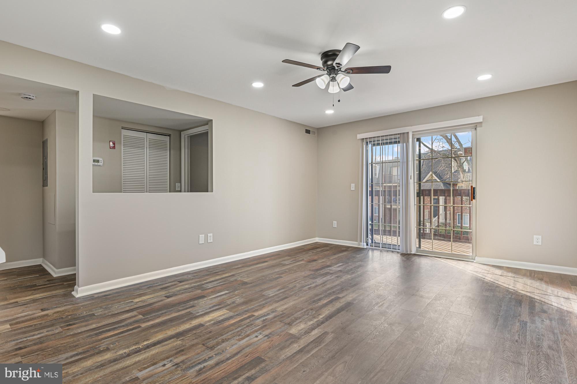 102 North Caroline Place, Unit 203 Dover, DE 19904 - Photo 2 of 12 a view of an empty room with a window and wooden floor