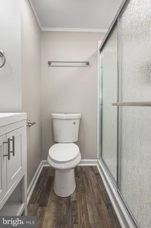 a bathroom with a toilet and a shower