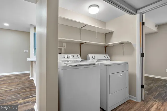 a utility room with cabinets washer and dryer