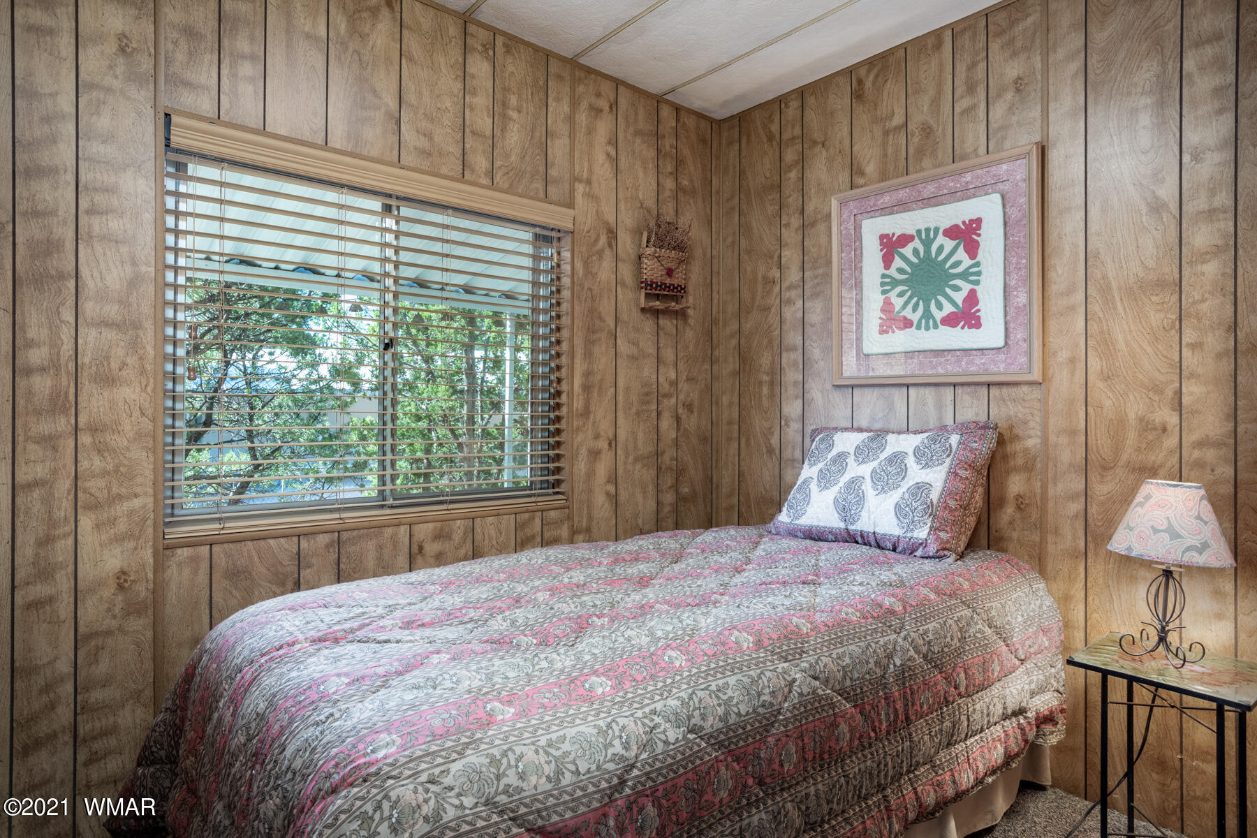 3536 Quail Run Road Overgaard, AZ 85933 - Photo 12 of 26 a large bed sitting in a bedroom next to a window