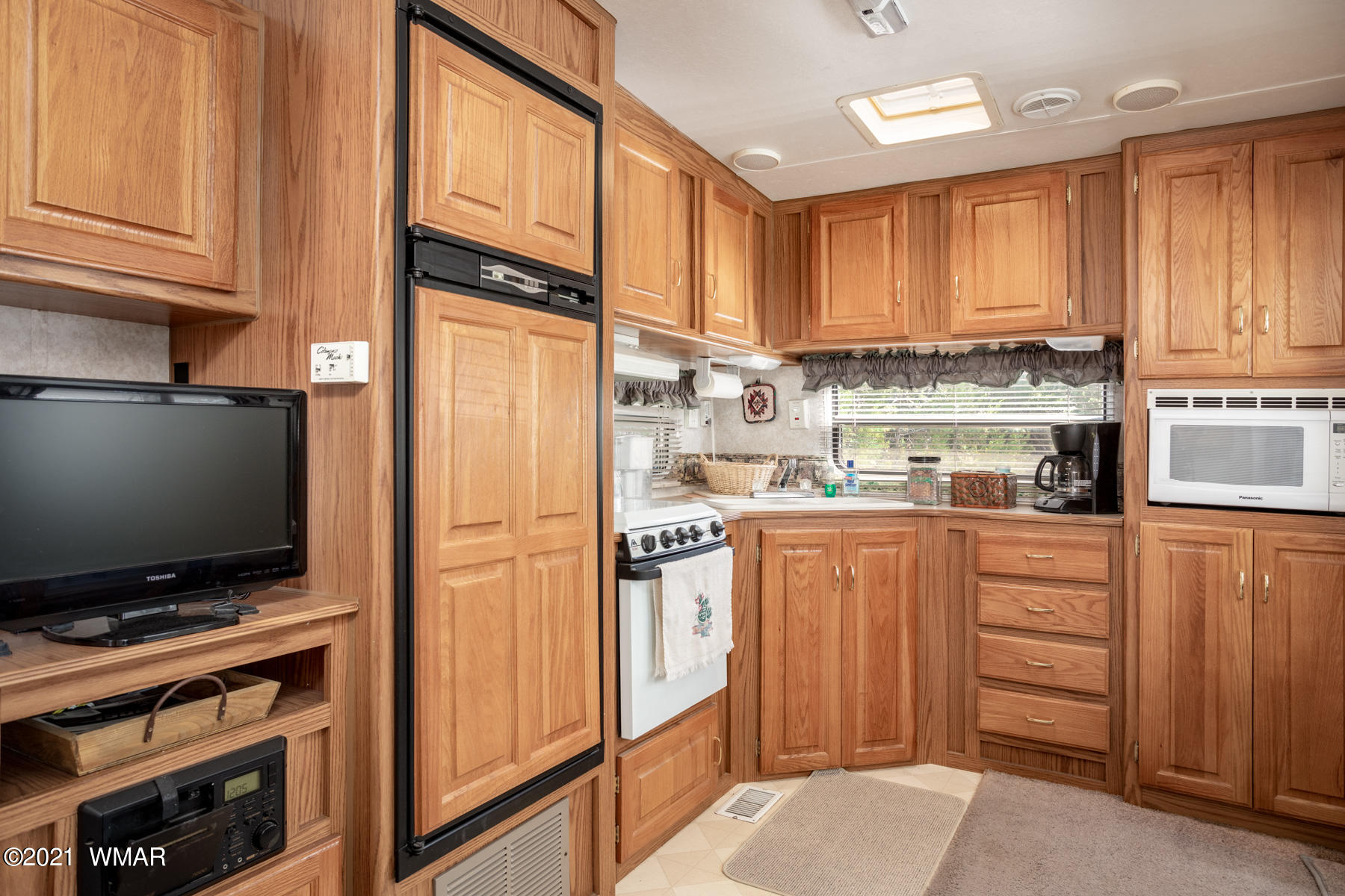 3536 Quail Run Road Overgaard, AZ 85933 - Photo 17 of 26 a kitchen with stainless steel appliances a refrigerator stove and cabinets