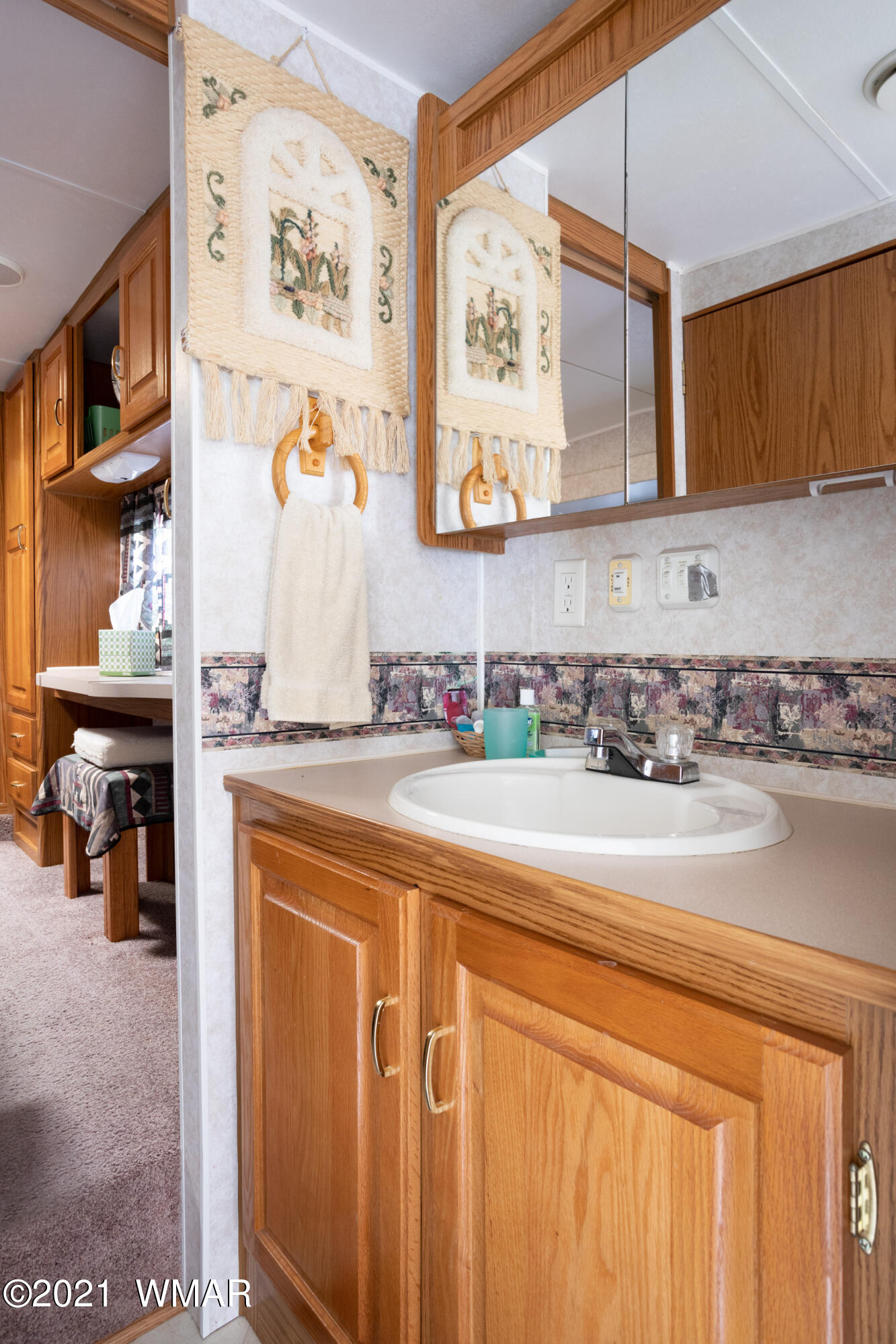 3536 Quail Run Road Overgaard, AZ 85933 - Photo 19 of 26 a bathroom with a sink a mirror and cabinets