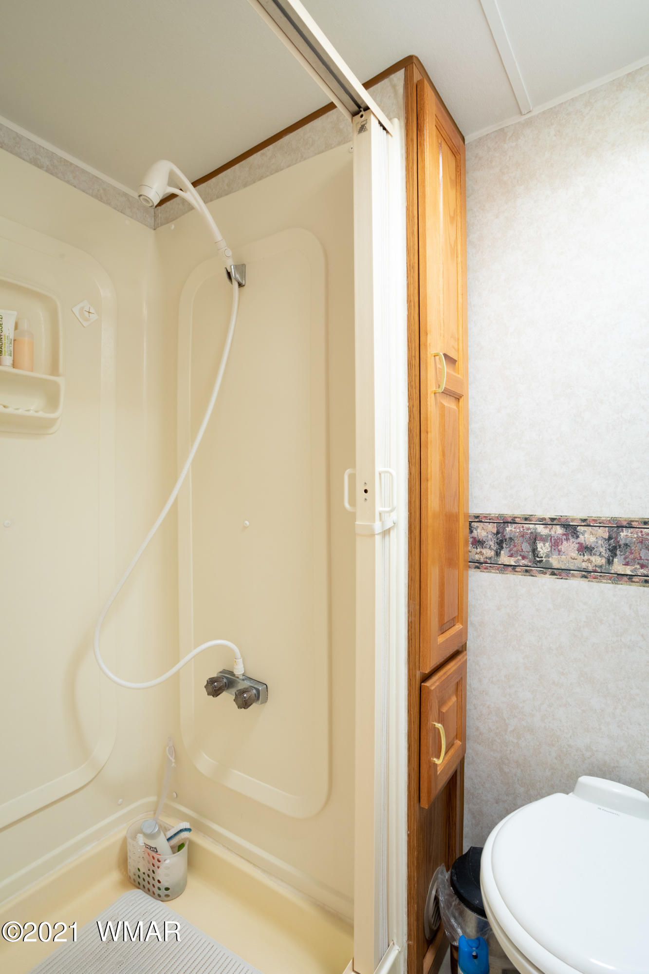 3536 Quail Run Road Overgaard, AZ 85933 - Photo 20 of 26 a bathroom with a shower a toilet and a shower