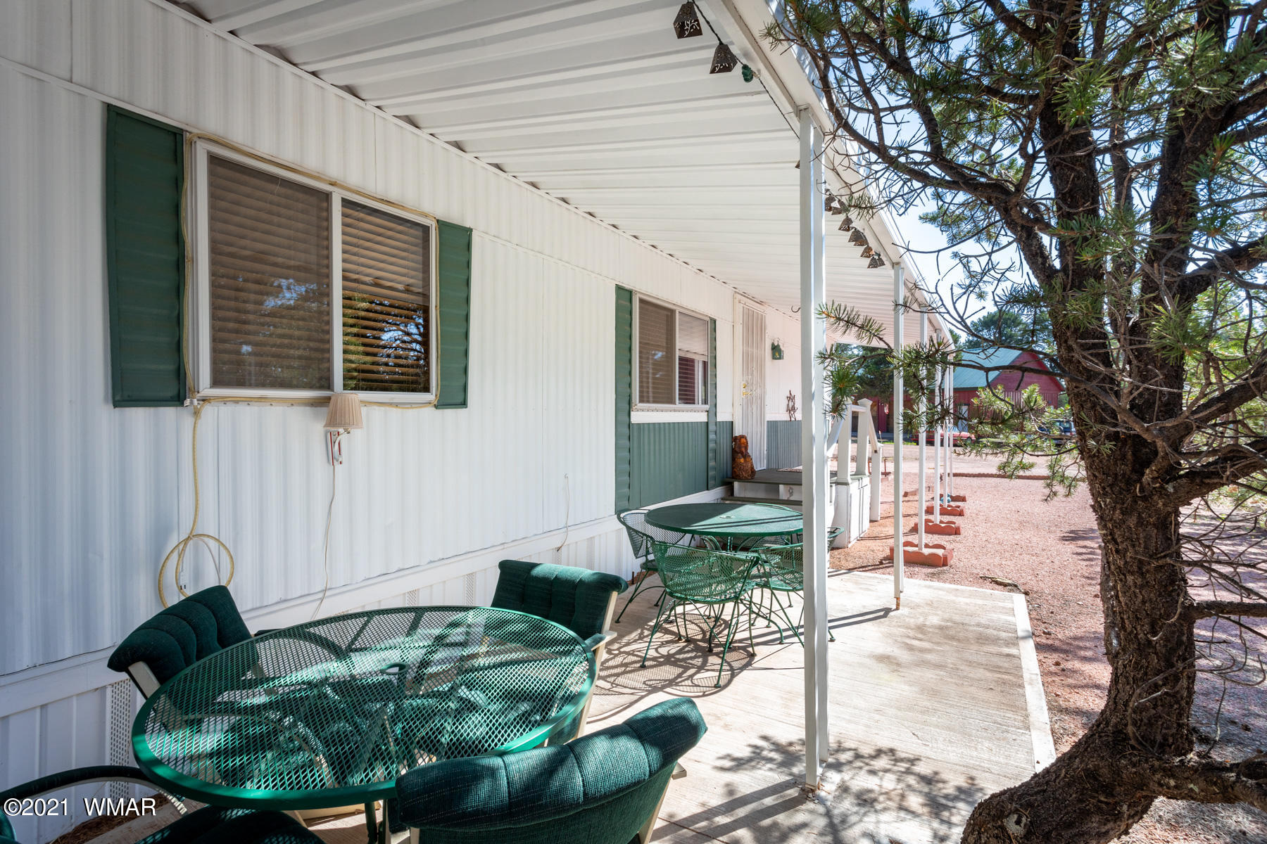 3536 Quail Run Road Overgaard, AZ 85933 - Photo 23 of 26 a front view of a house with porch and sitting area