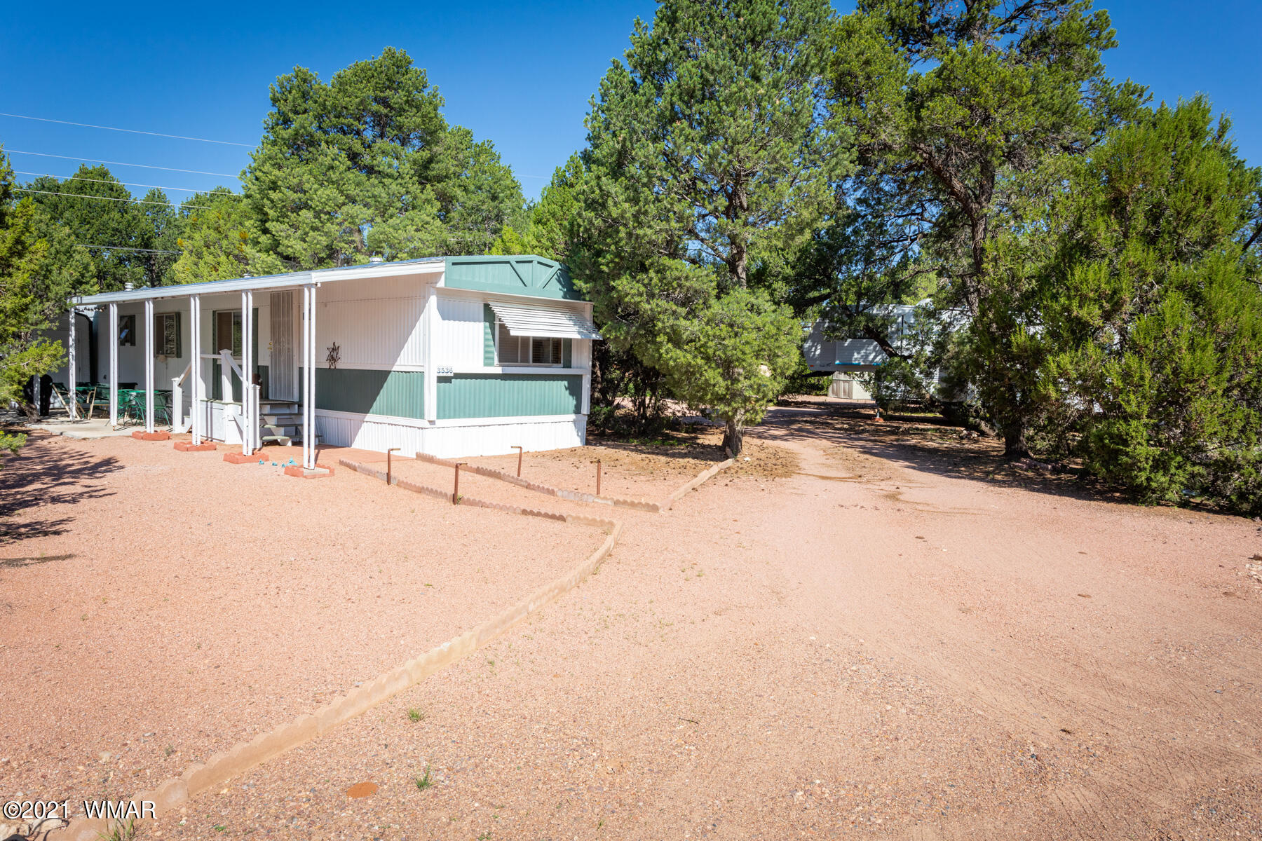 3536 Quail Run Road Overgaard, AZ 85933 - Photo 26 of 26 a street view with wooden fence and trees