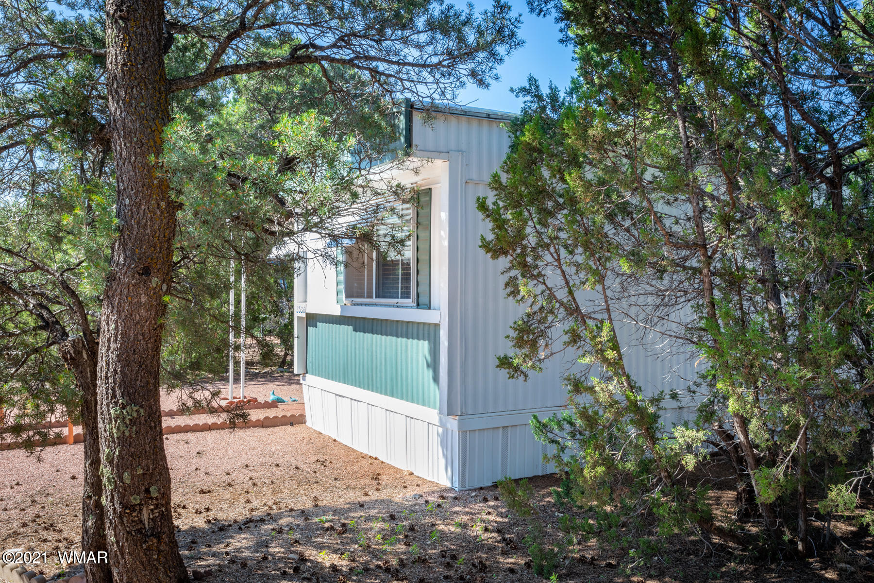 3536 Quail Run Road Overgaard, AZ 85933 - Photo 3 of 26 a view of a house with a tree in the backyard