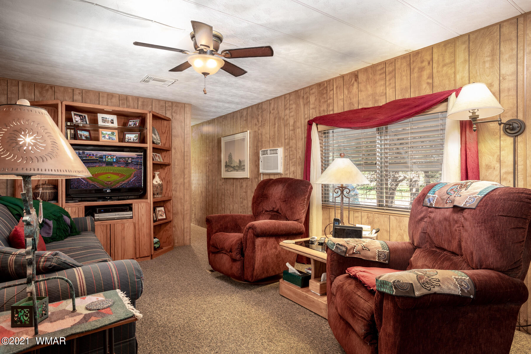 3536 Quail Run Road Overgaard, AZ 85933 - Photo 5 of 26 a living room with furniture a ceiling fan and a window