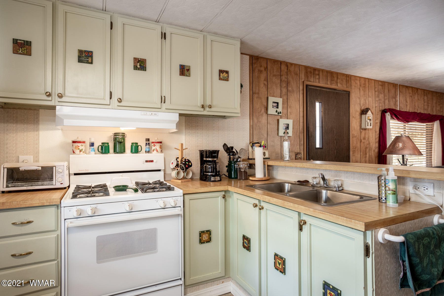 3536 Quail Run Road Overgaard, AZ 85933 - Photo 8 of 26 a kitchen with granite countertop white cabinets and white appliances