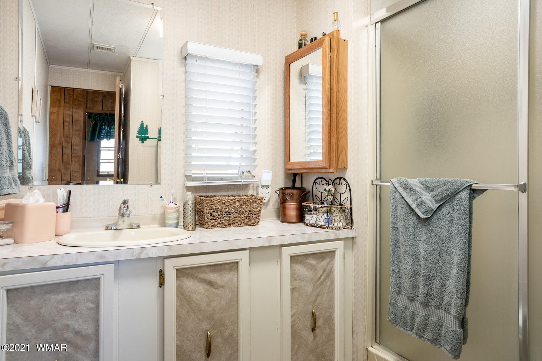 3536 Quail Run Road Overgaard, AZ 85933 - Photo 10 of 26 a bathroom with a granite countertop sink and a mirror