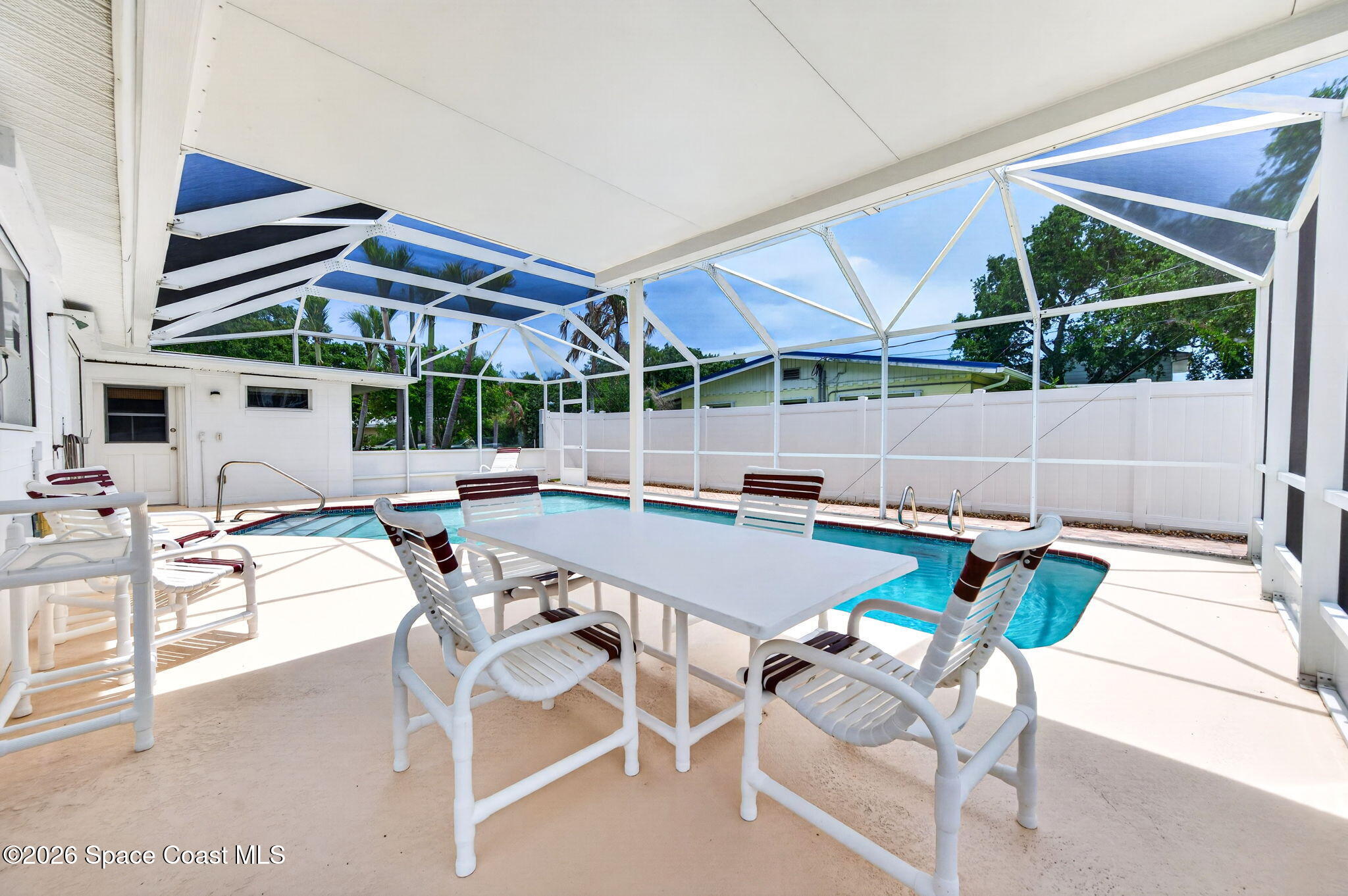 935 Samar Road Cocoa Beach, FL 32931 - Photo 19 of 22 a patio with a table and chairs