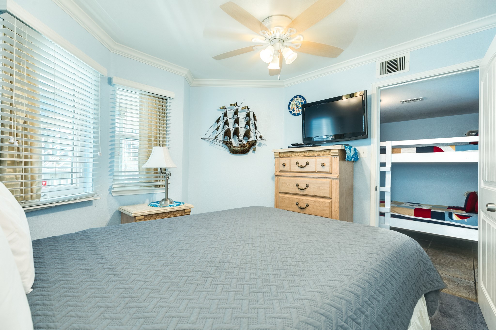 10811 Termini-San Luis Pass Road, Unit 1201 Galveston, TX 77554 - Photo 19 of 25 a bedroom with furniture and a flat screen tv