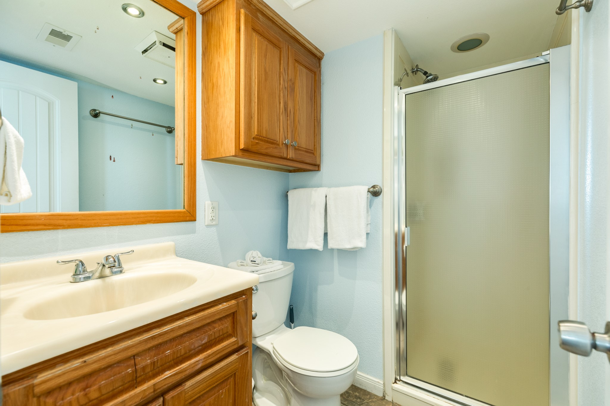10811 Termini-San Luis Pass Road, Unit 1201 Galveston, TX 77554 - Photo 21 of 25 a bathroom with a sink a toilet and shower