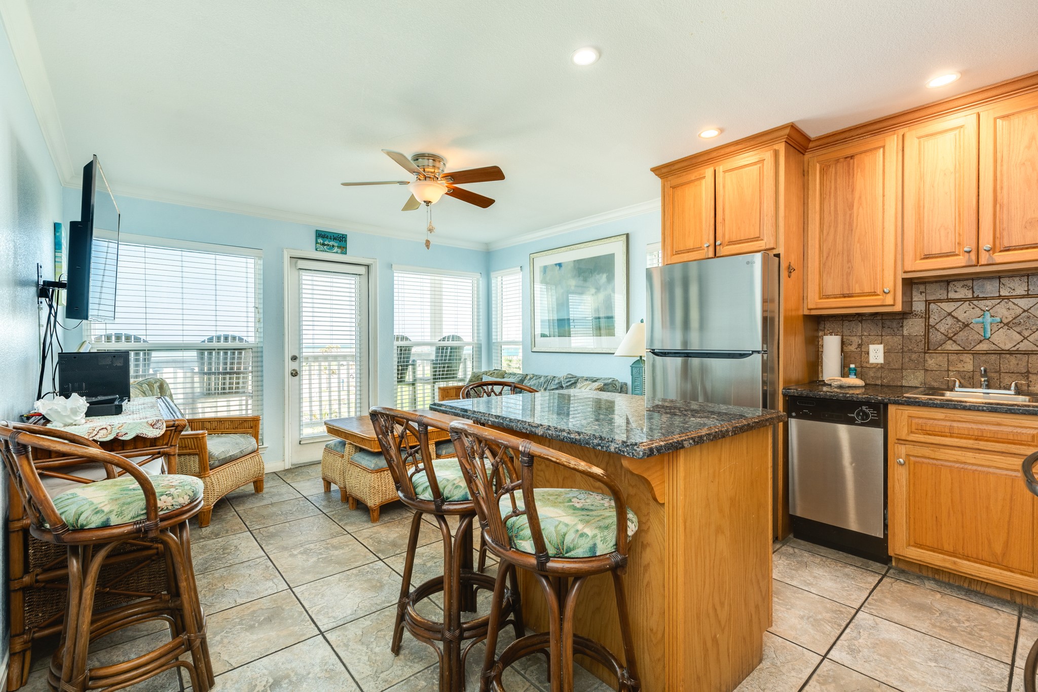 10811 Termini-San Luis Pass Road, Unit 1201 Galveston, TX 77554 - Photo 8 of 25 a view of a kitchen with kitchen island granite countertop appliances cabinets and furniture