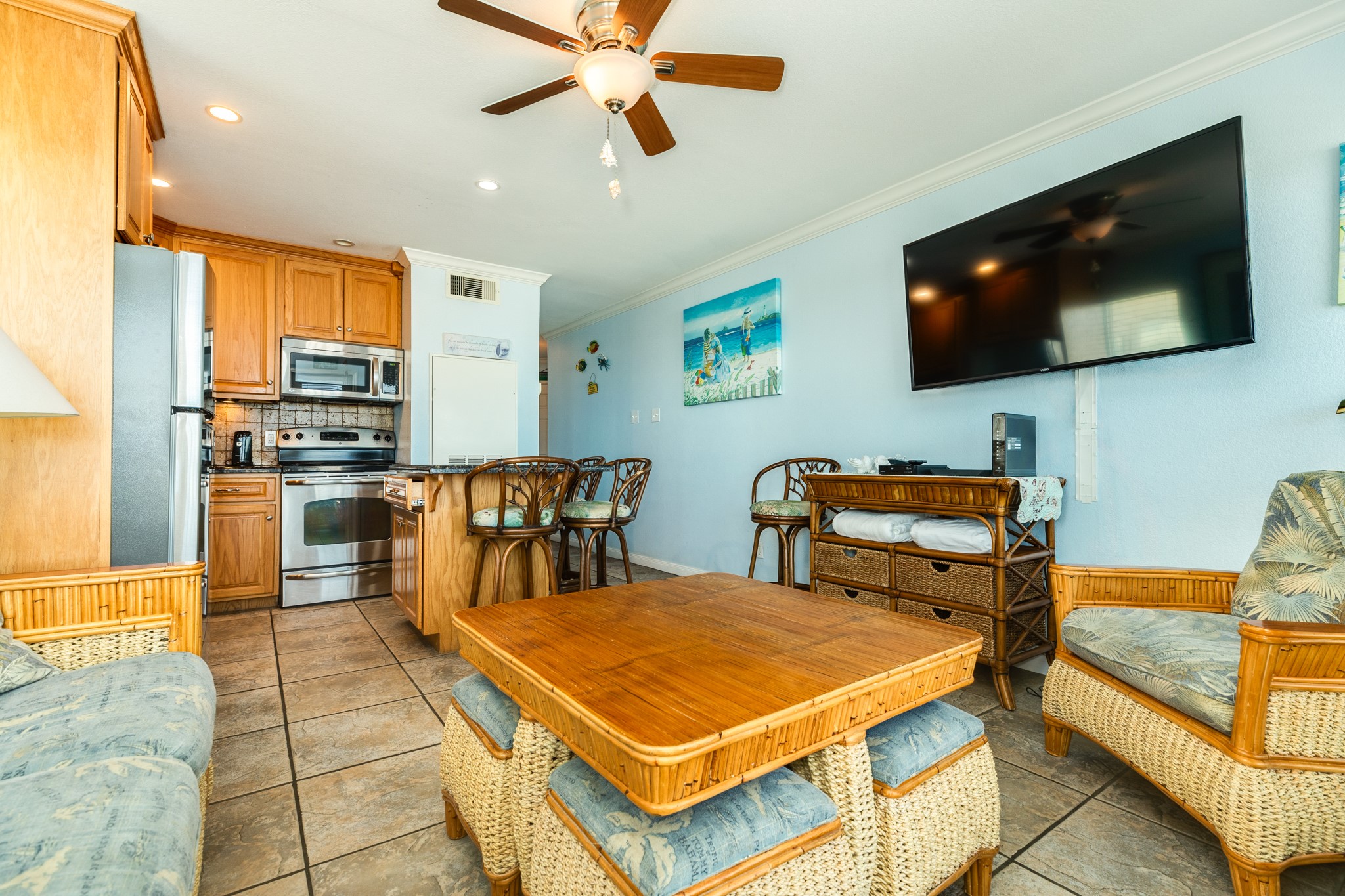 10811 Termini-San Luis Pass Road, Unit 1201 Galveston, TX 77554 - Photo 10 of 25 a living room with stainless steel appliances furniture and a flat screen tv