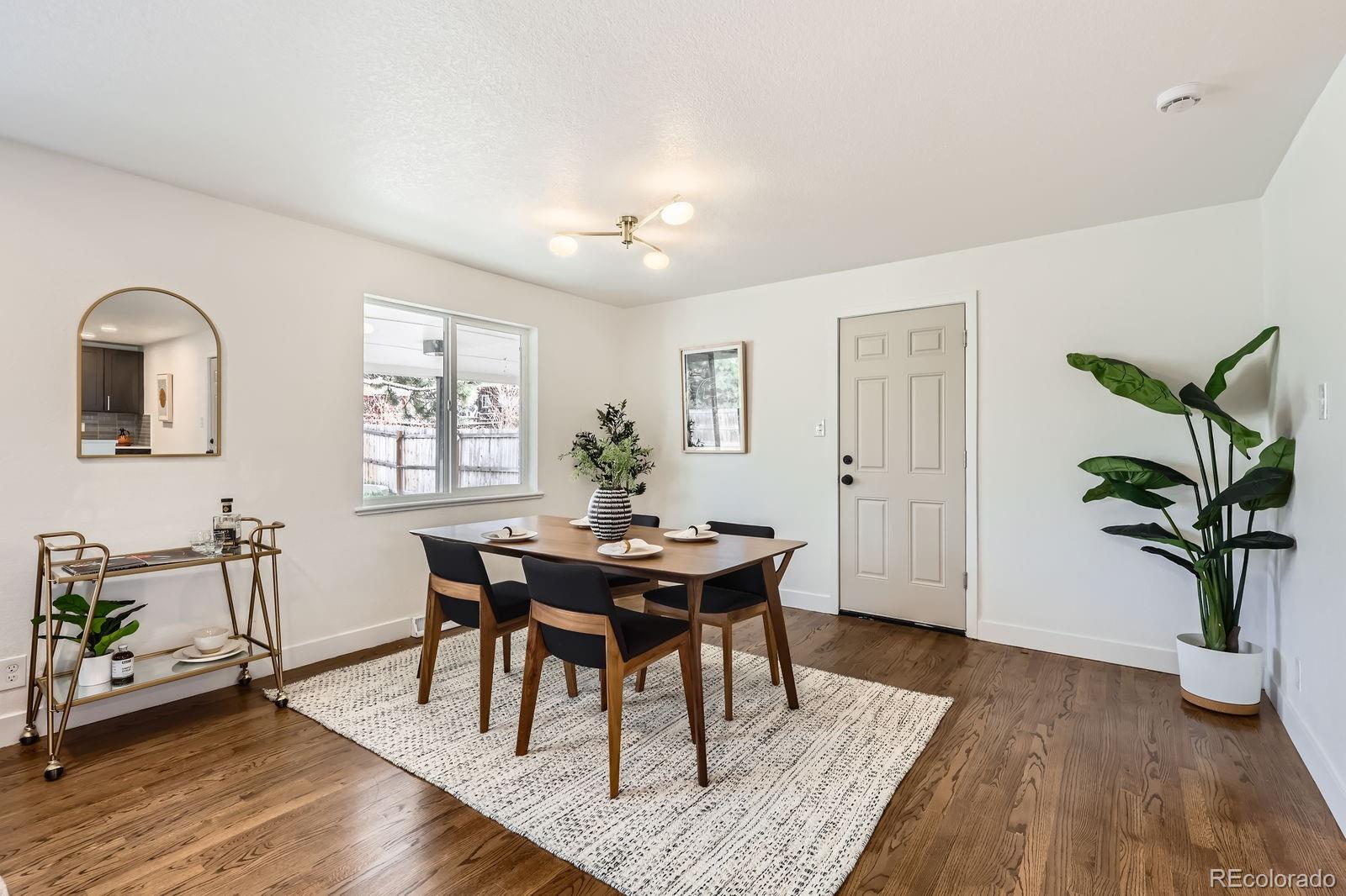 9455 West 37th Avenue Wheat Ridge, CO 80033 - Photo 11 of 33 a view of a dining room with furniture and wooden floor