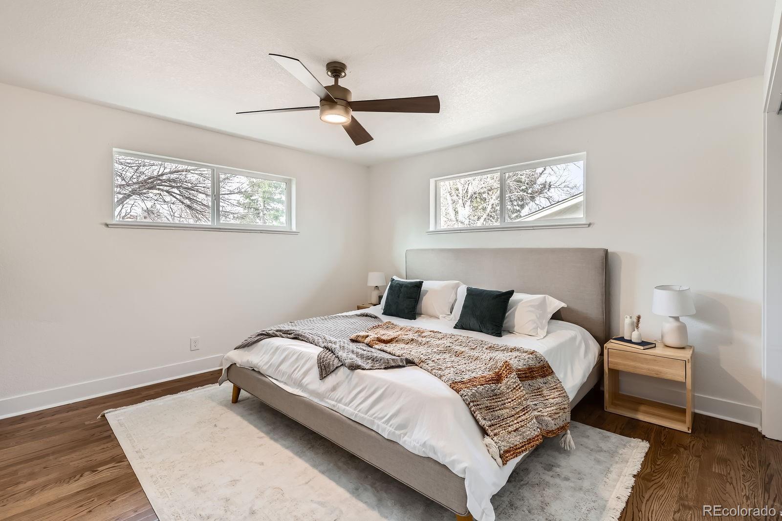 9455 West 37th Avenue Wheat Ridge, CO 80033 - Photo 12 of 33 a bedroom with a bed and wooden floor