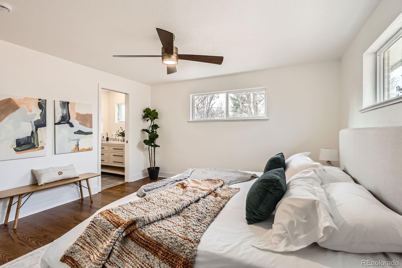 9455 West 37th Avenue Wheat Ridge, CO 80033 - Photo 13 of 33 a bed sitting in a bedroom next to a window with a bedroom
