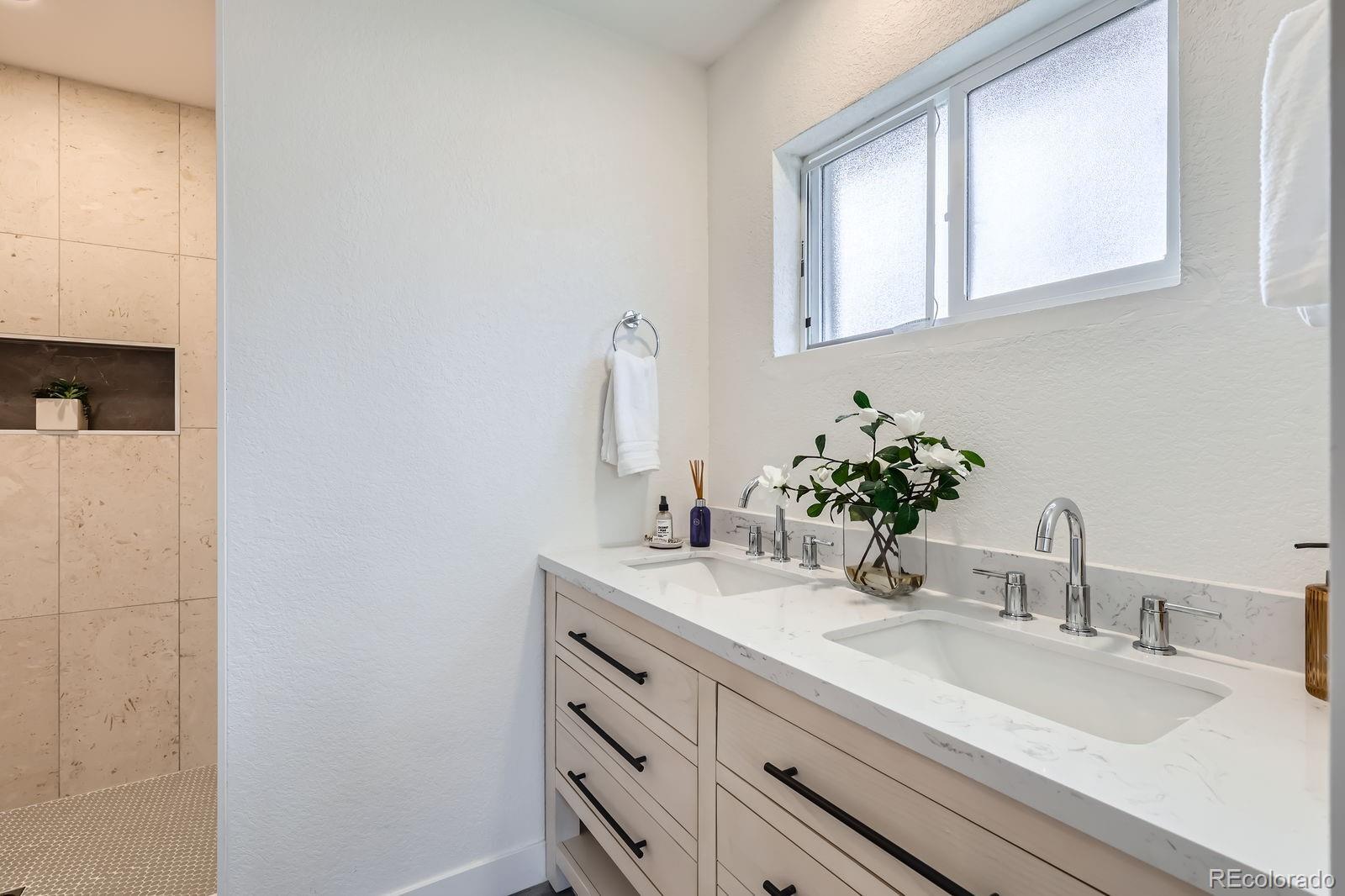 9455 West 37th Avenue Wheat Ridge, CO 80033 - Photo 15 of 33 a bathroom with a sink and a mirror