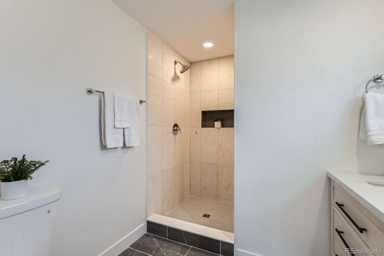 9455 West 37th Avenue Wheat Ridge, CO 80033 - Photo 16 of 33 a bathroom with a shower and a sink