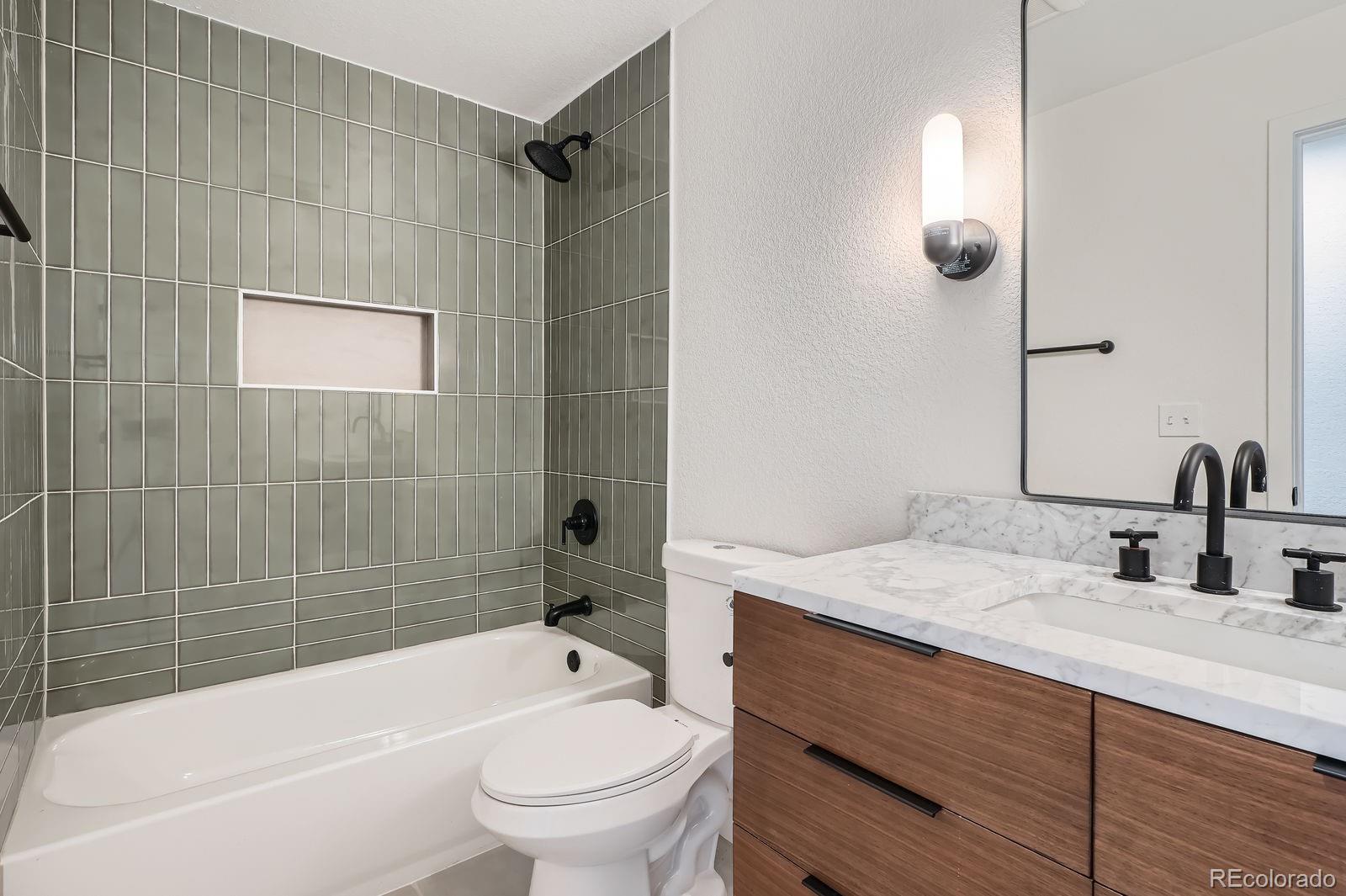 9455 West 37th Avenue Wheat Ridge, CO 80033 - Photo 17 of 33 a bathroom with a sink toilet and shower
