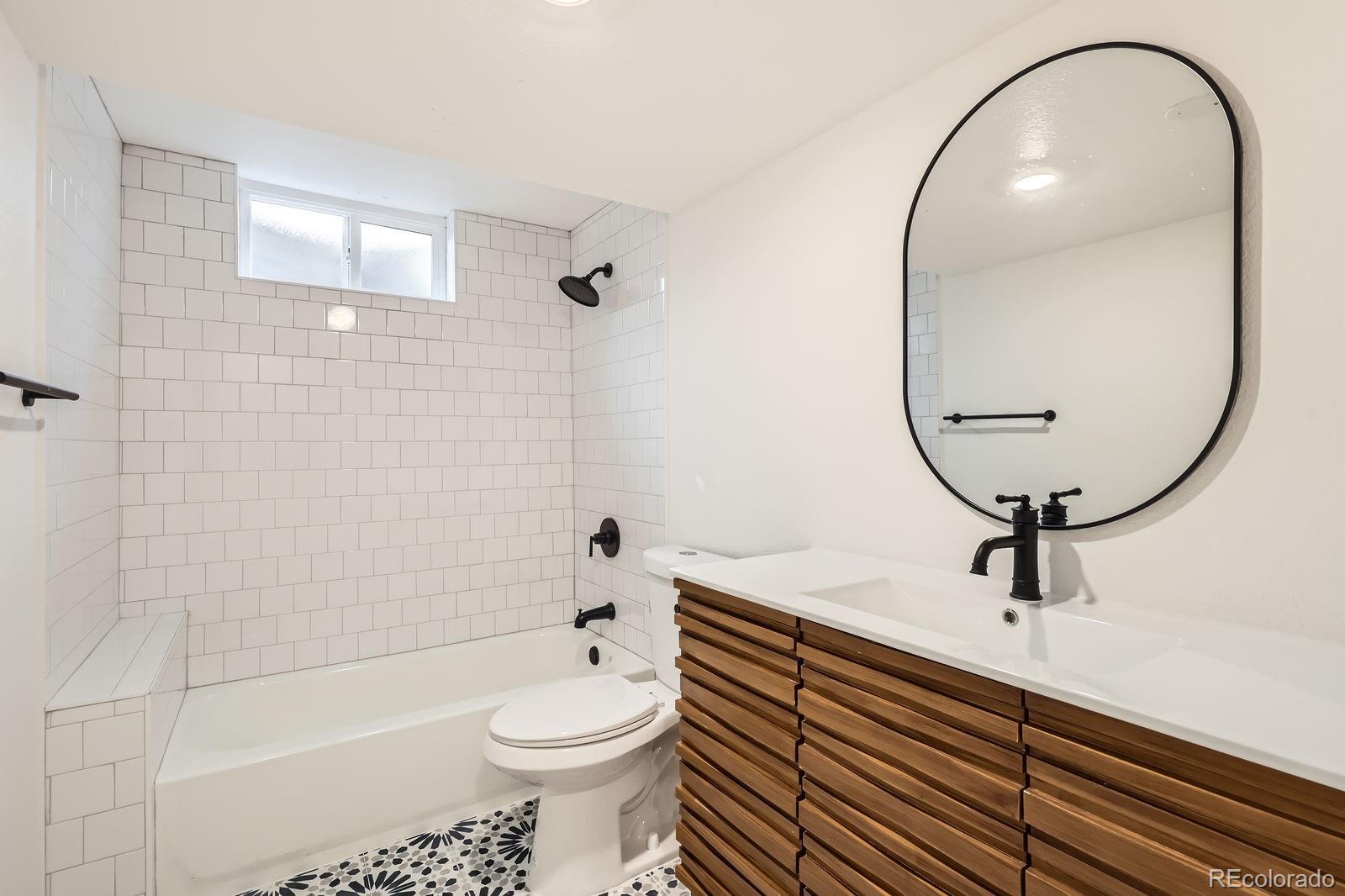 9455 West 37th Avenue Wheat Ridge, CO 80033 - Photo 24 of 33 a bathroom with a sink a toilet and a mirror