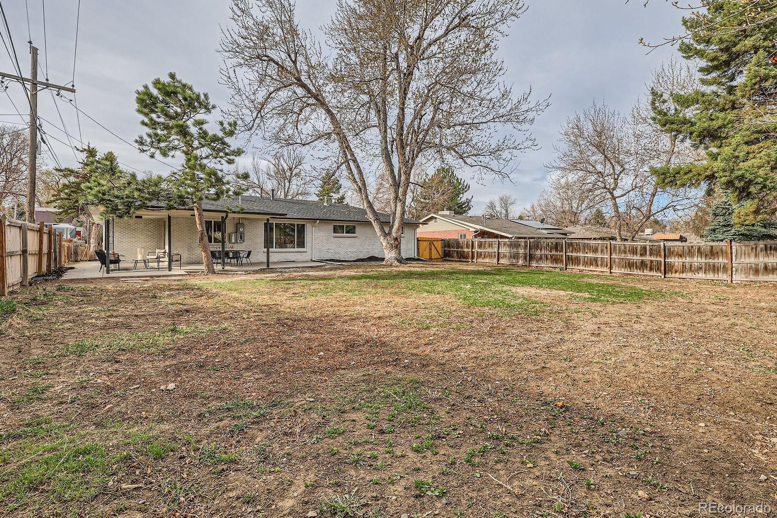 9455 West 37th Avenue Wheat Ridge, CO 80033 - Photo 29 of 33 a front view of a house with a yard
