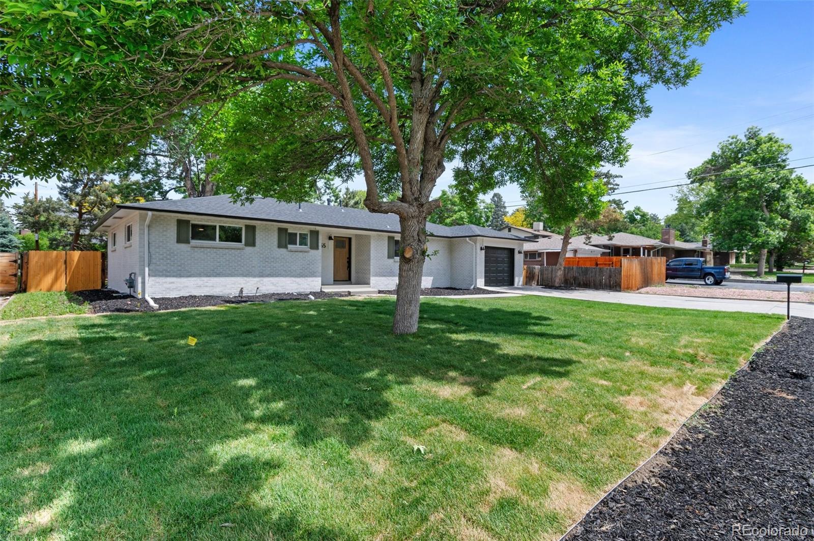 9455 West 37th Avenue Wheat Ridge, CO 80033 - Photo 30 of 33 a front view of house with yard and green space