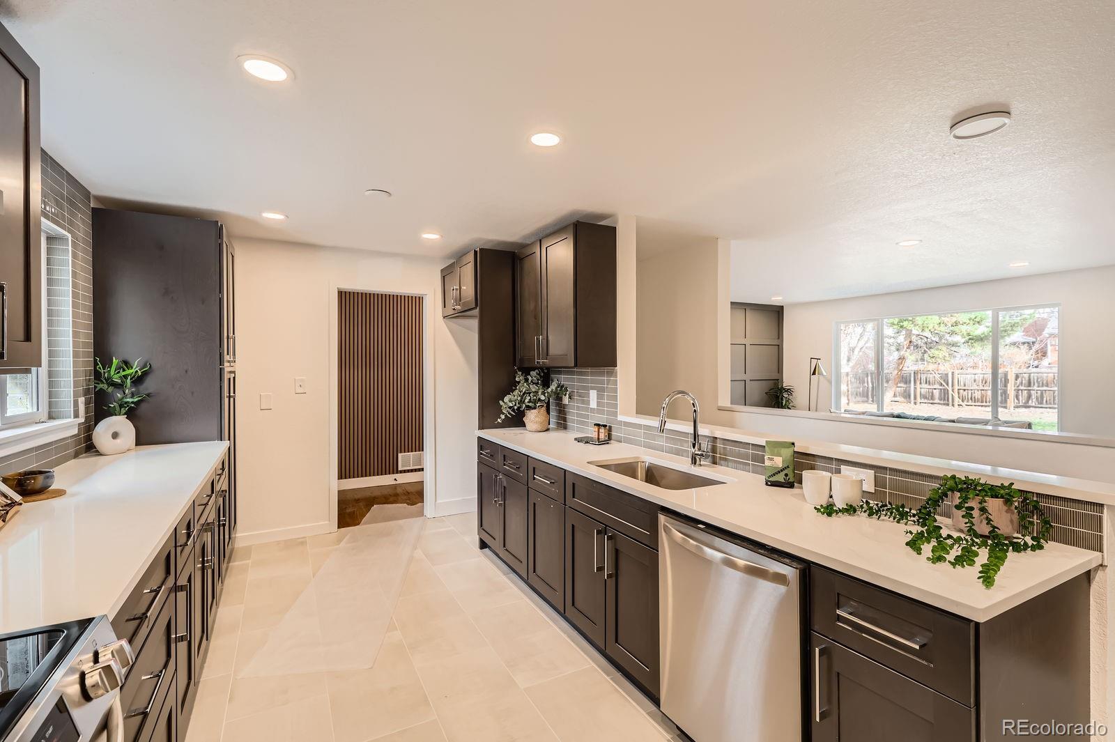 9455 West 37th Avenue Wheat Ridge, CO 80033 - Photo 8 of 33 a large kitchen with a sink and a large window