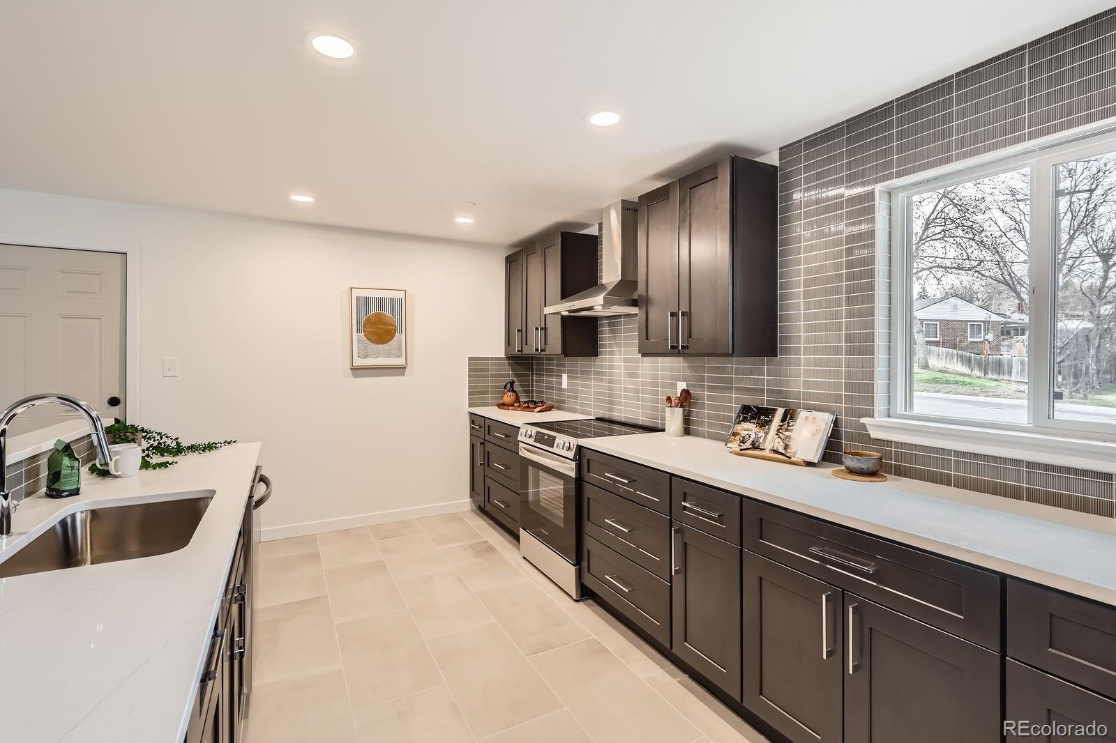 9455 West 37th Avenue Wheat Ridge, CO 80033 - Photo 10 of 33 a kitchen with a sink stove and cabinets