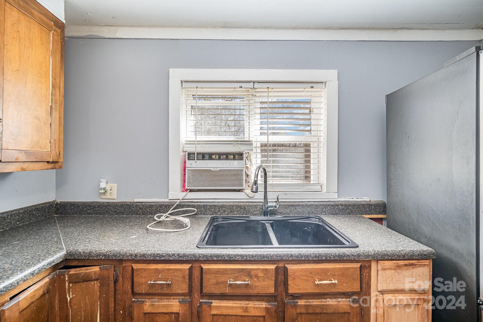 3704 State Rd S-29-315 Lancaster, SC 29720 - Photo 9 of 30 a kitchen with a sink cabinets and window
