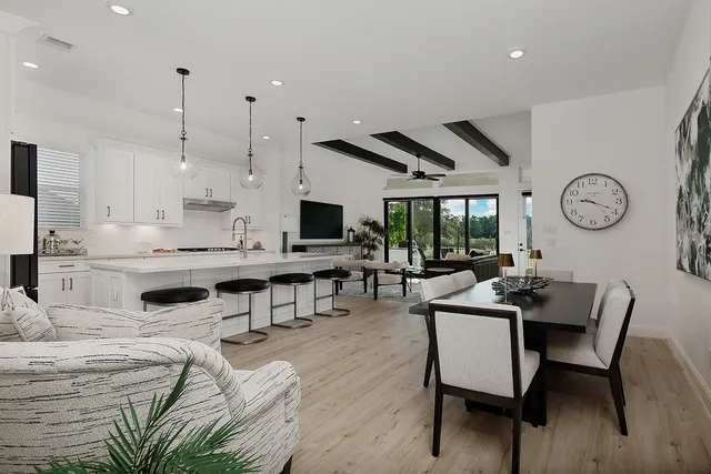 a living room with lots of furniture and kitchen view