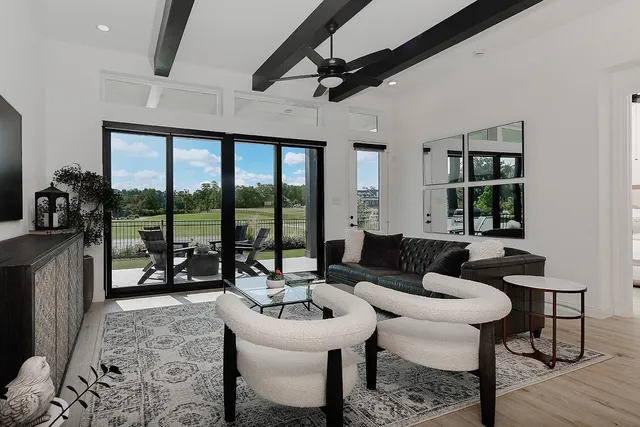 a living room with furniture and a floor to ceiling window