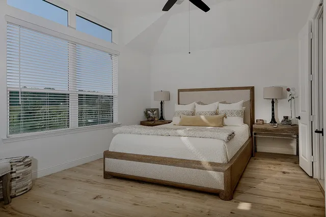 a large bed sitting in a bedroom next to a window