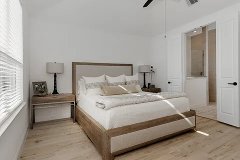 a bedroom with a bed and window