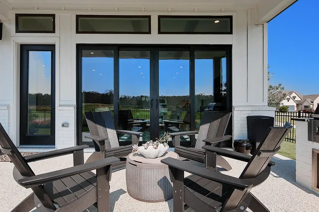 a living room with a couch and a floor to ceiling window
