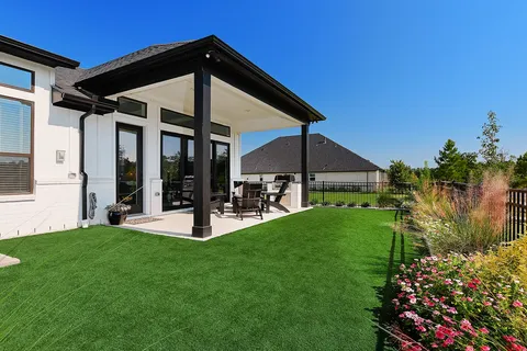 a view of a house with backyard sitting area and garden