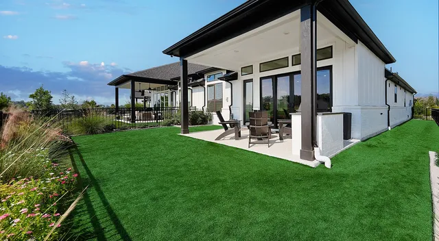 a porch with a table and chairs under an umbrella