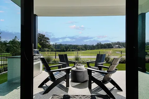 a view of a lake with furniture and city view