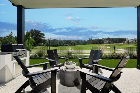 a view of a lake with a table and chairs