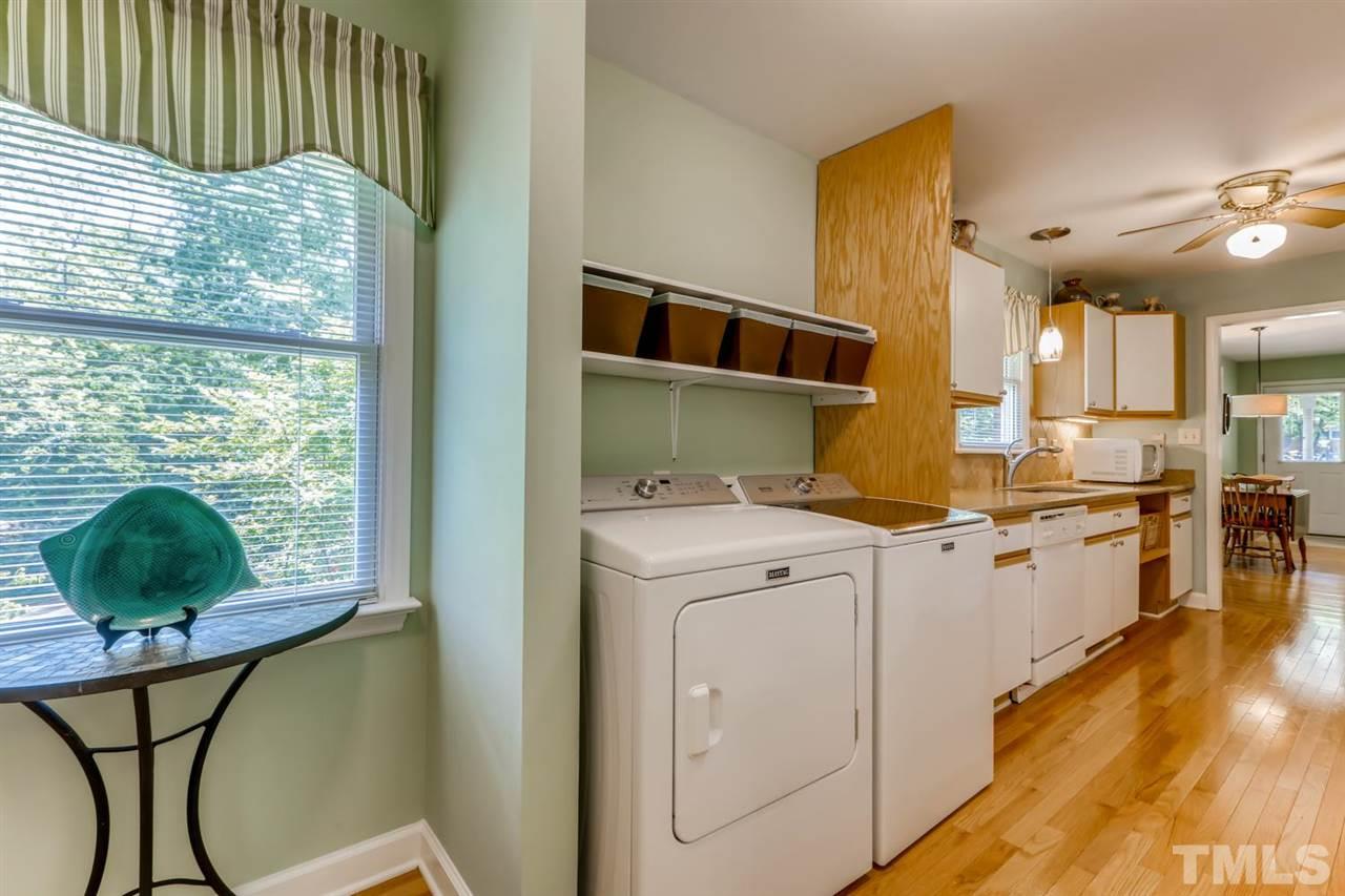1405 Geneva Street Raleigh, NC 27606 - Photo 22 of 30 a kitchen that has a lot of cabinets and wooden floor