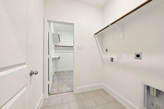 a kitchen with kitchen island granite countertop wooden cabinets and refrigerator