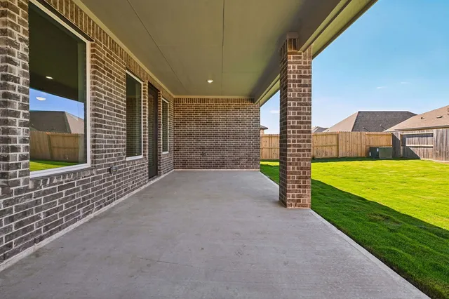 a large tree in front of a house with a big yard