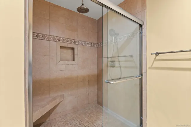 a bathroom with a glass shower door