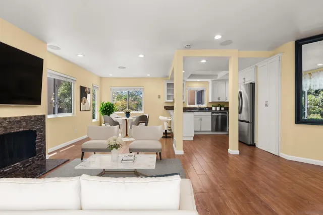 a living room with fireplace furniture and a flat screen tv