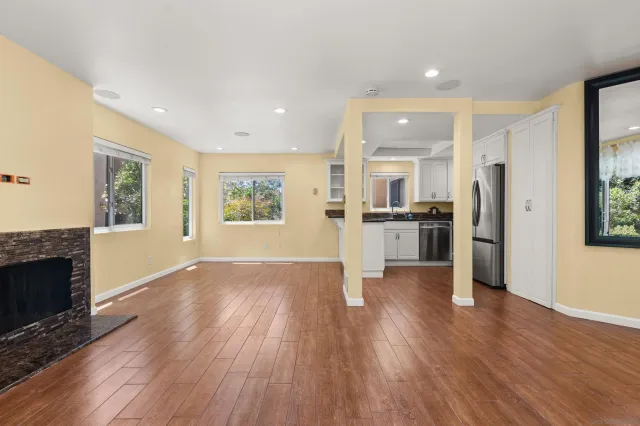 a view of kitchen with wooden floor electronic appliances and window