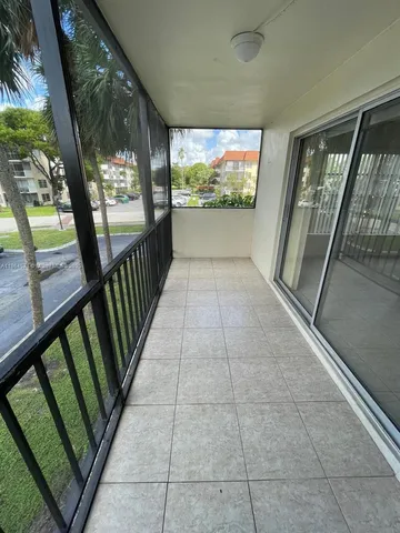 a view of a room with wooden floor and door