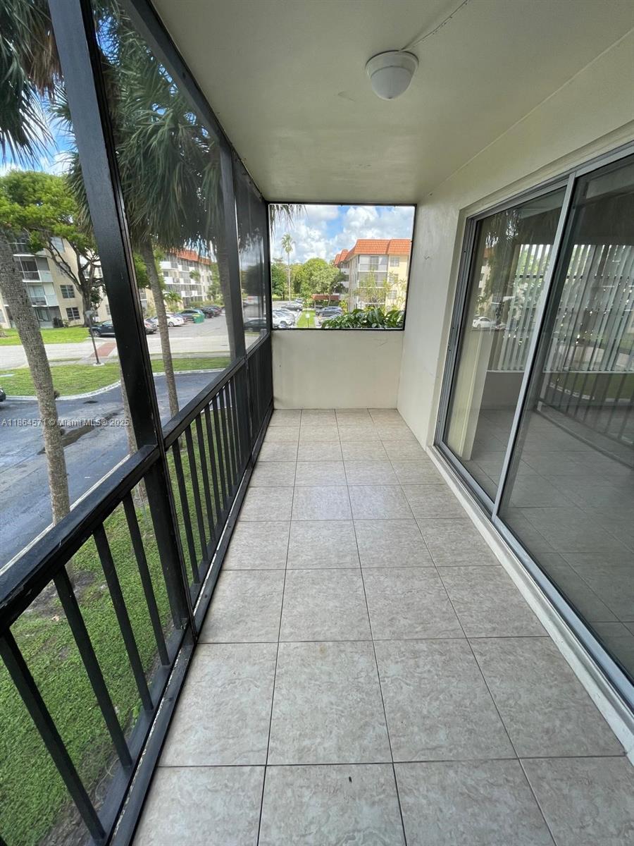 4164 Inverrary Drive, Unit 215 Lauderhill, FL 33319 - Photo 14 of 27 a view of a room with wooden floor and door